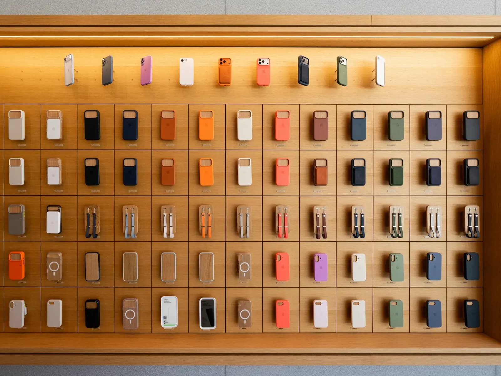A mobile phone shop interior in Kathmandu with backlit display walls and glass cabinets